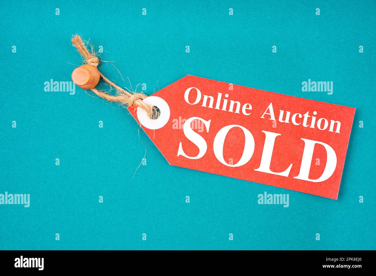 Red tag Online auction sold hanging with wooden push pin on green ...