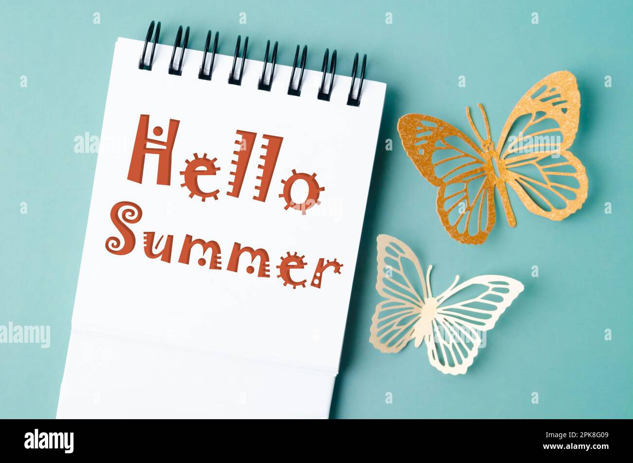 Hello summer on note book and paper butterfly carve. Stock Photo