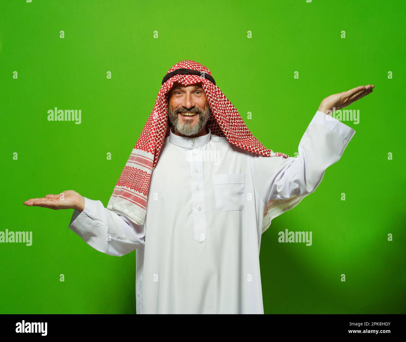 Arab mature man depicts scales with his hands at different levels. Concept of decision-making, weighing options, and finding balance. ideas of justice, equality, and fairness, using metaphor of scales to depict importance of making right choice, comparing options, and achieving balance in life. High quality photo Stock Photo