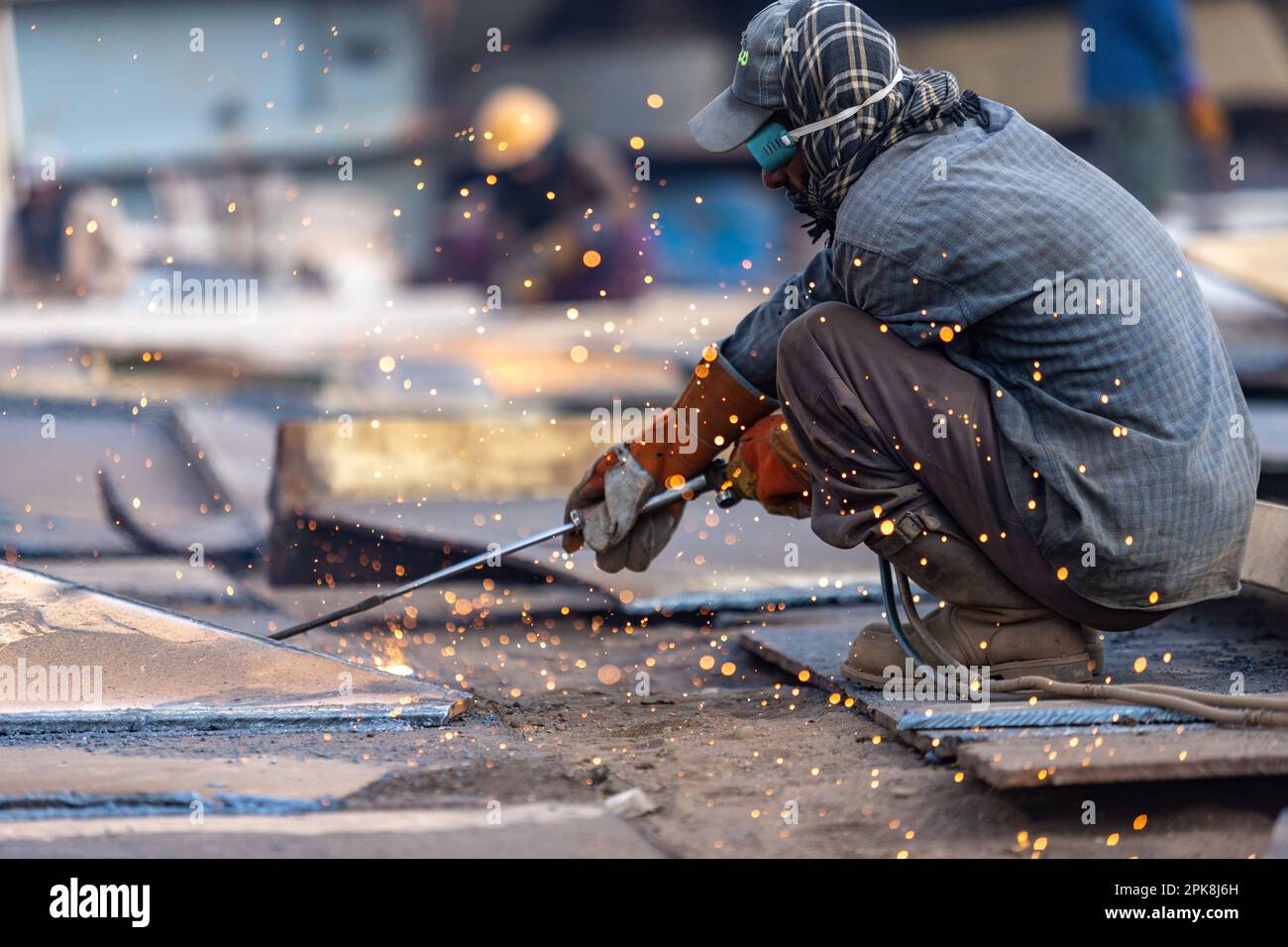 Gadani Pakistan August 2021, a worker wearing yellow safety helmet