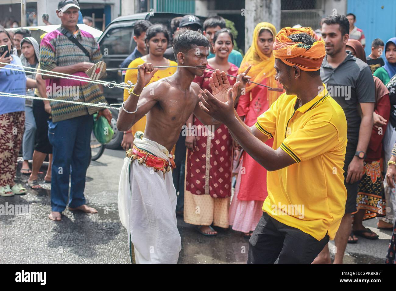 A Hindu man of the Tamil tribe participates in the cheek and body ...