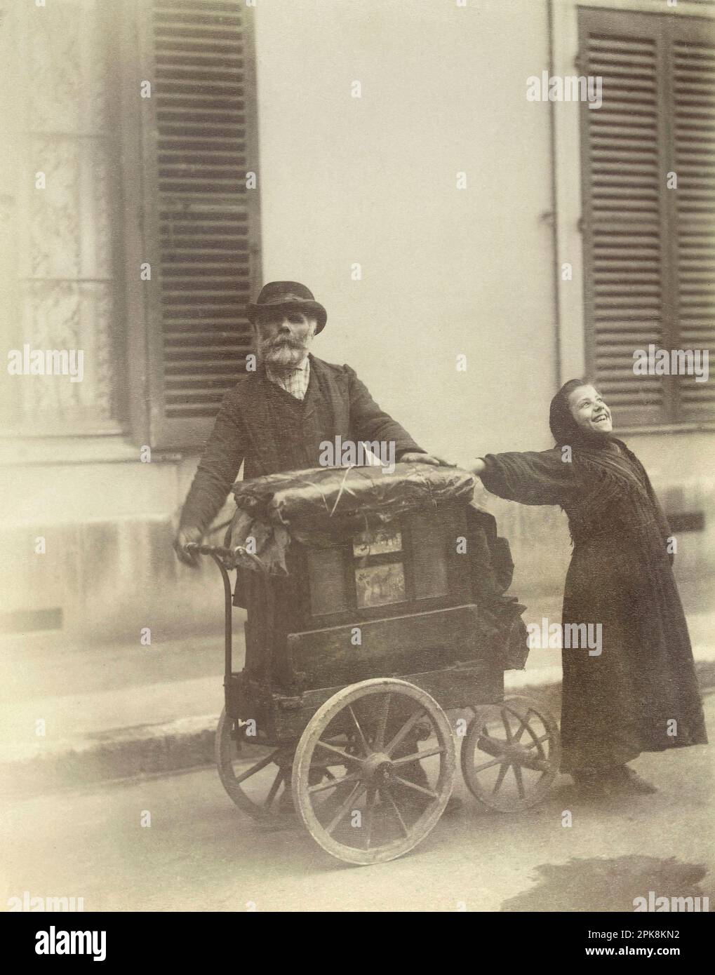Barrel organ player with a young street singer, photography by Eugène Atget, in 1898 ( popular songs in the street. ) Stock Photo