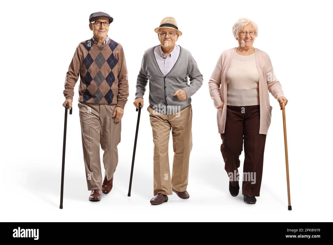 Group of pensioners walking towards camera isolated on white background Stock Photo