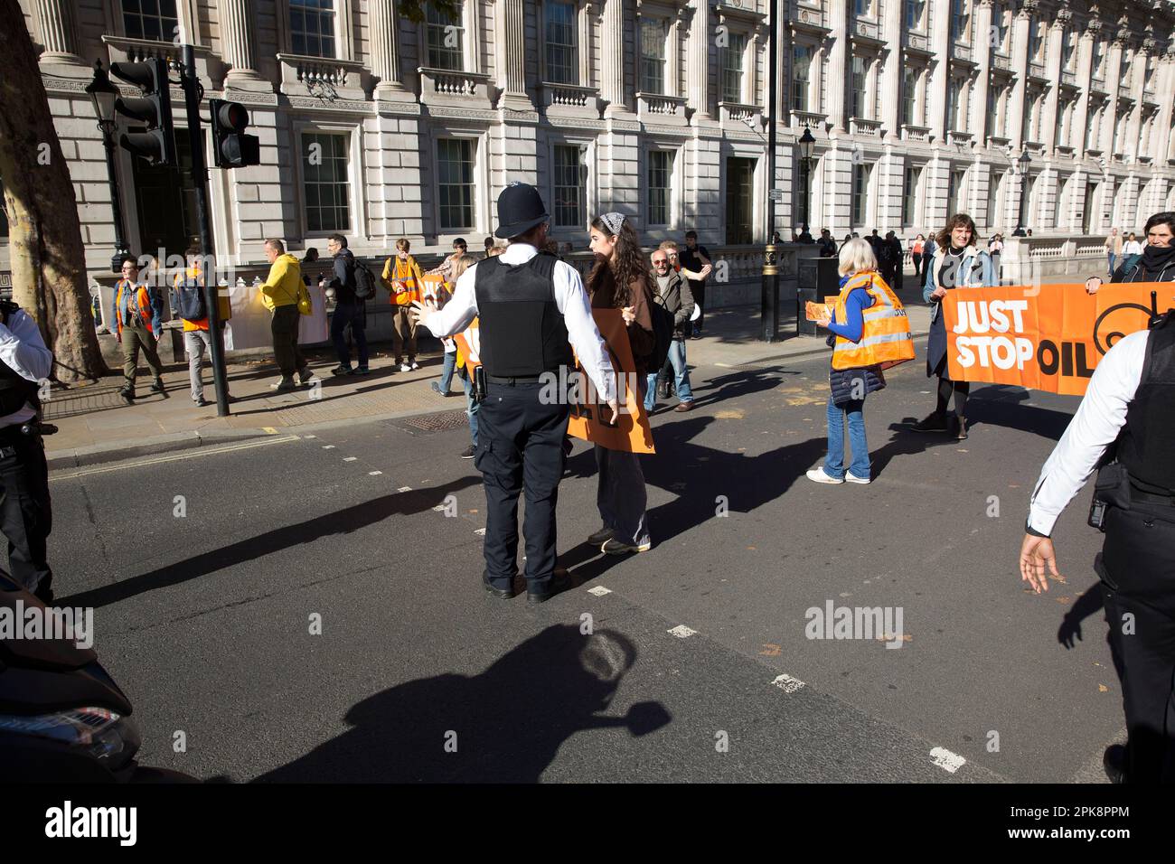 ‘Just Stop Oil’ activists try to hold a banner in front of the traffic