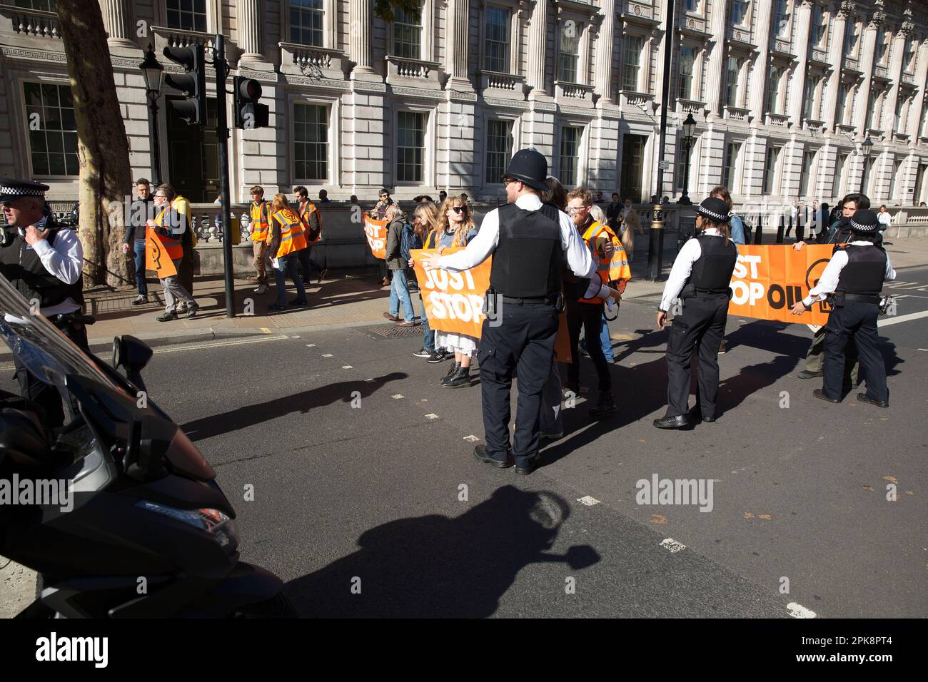 ‘Just Stop Oil’ activists try to hold a banner in front of the traffic