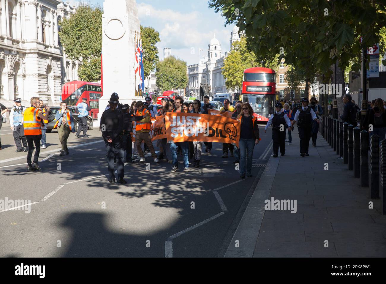 ‘Just Stop Oil’ activists try to hold a banner in front of the traffic