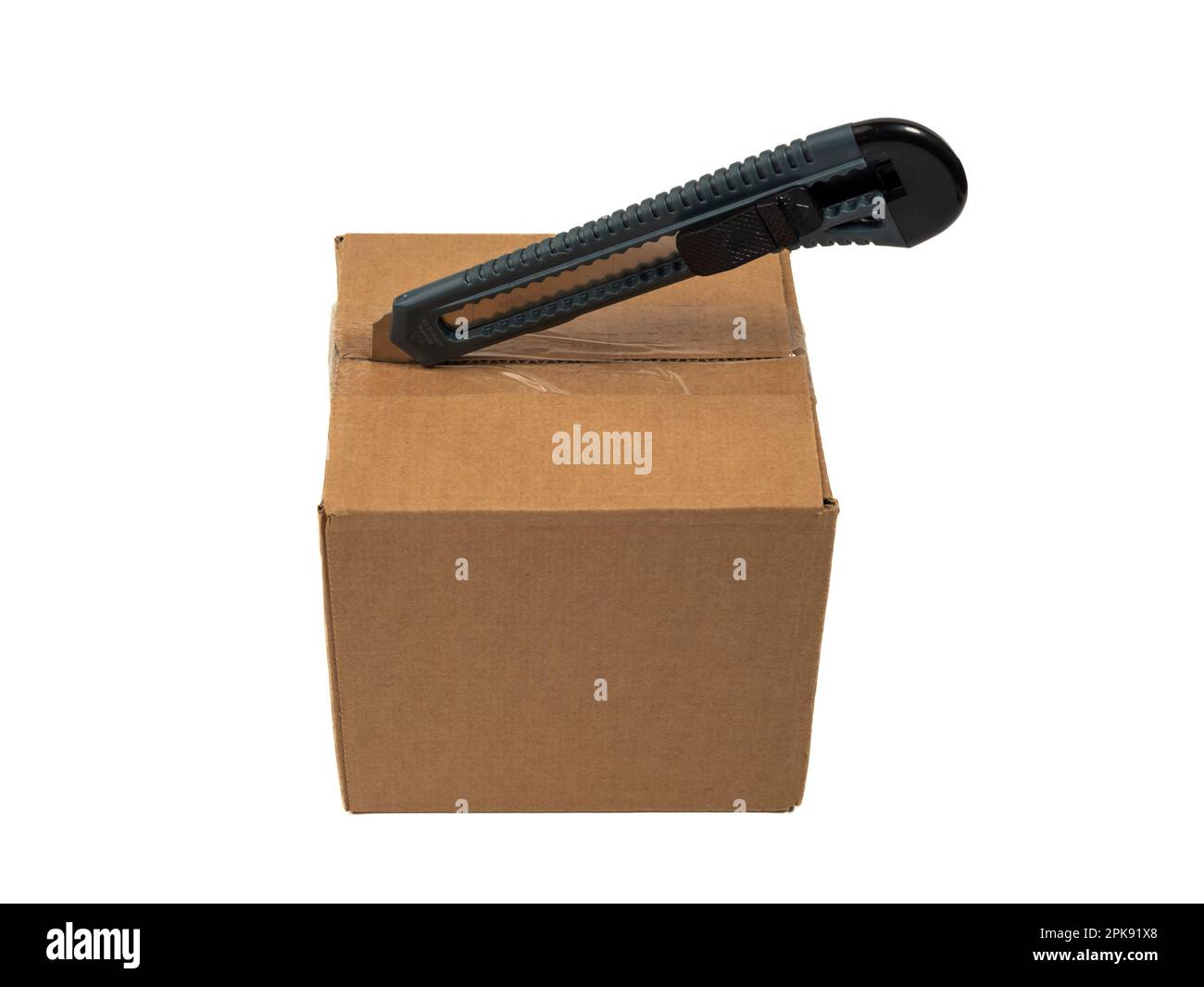 The cardboard box is opened with a knife. White background Stock Photo