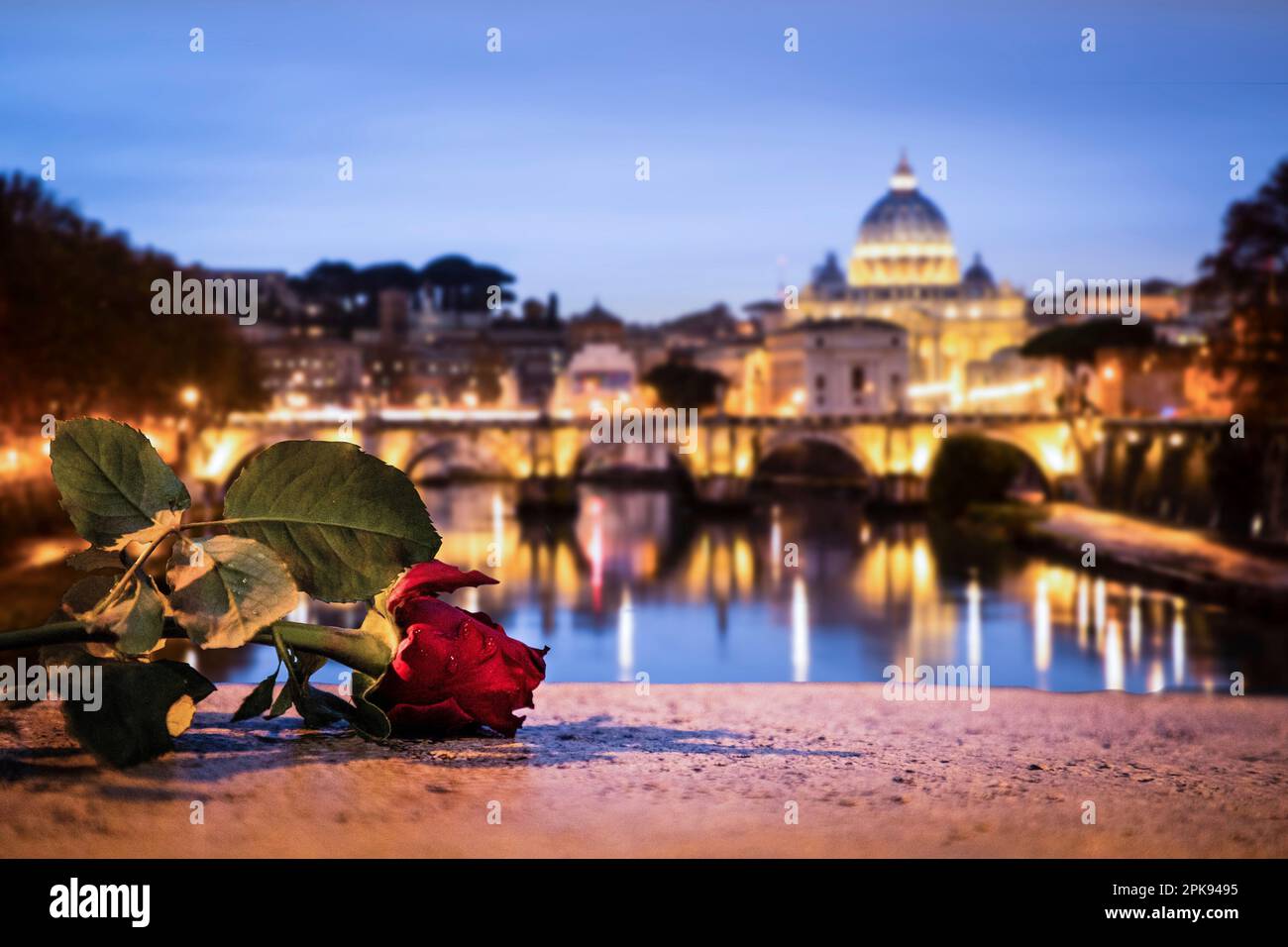 View from the Ponte Umberto I bridge over the Angel Bridge / Pons Aelius / Ponte Sant'Angelo bridge to the Vatican and St. Peter's Basilica in the evening Stock Photo