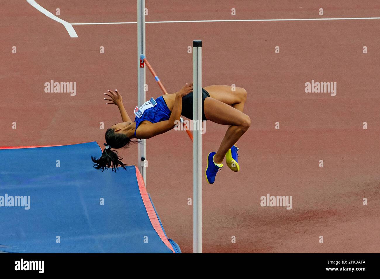 female athlete high jump side view in summer athletics championships