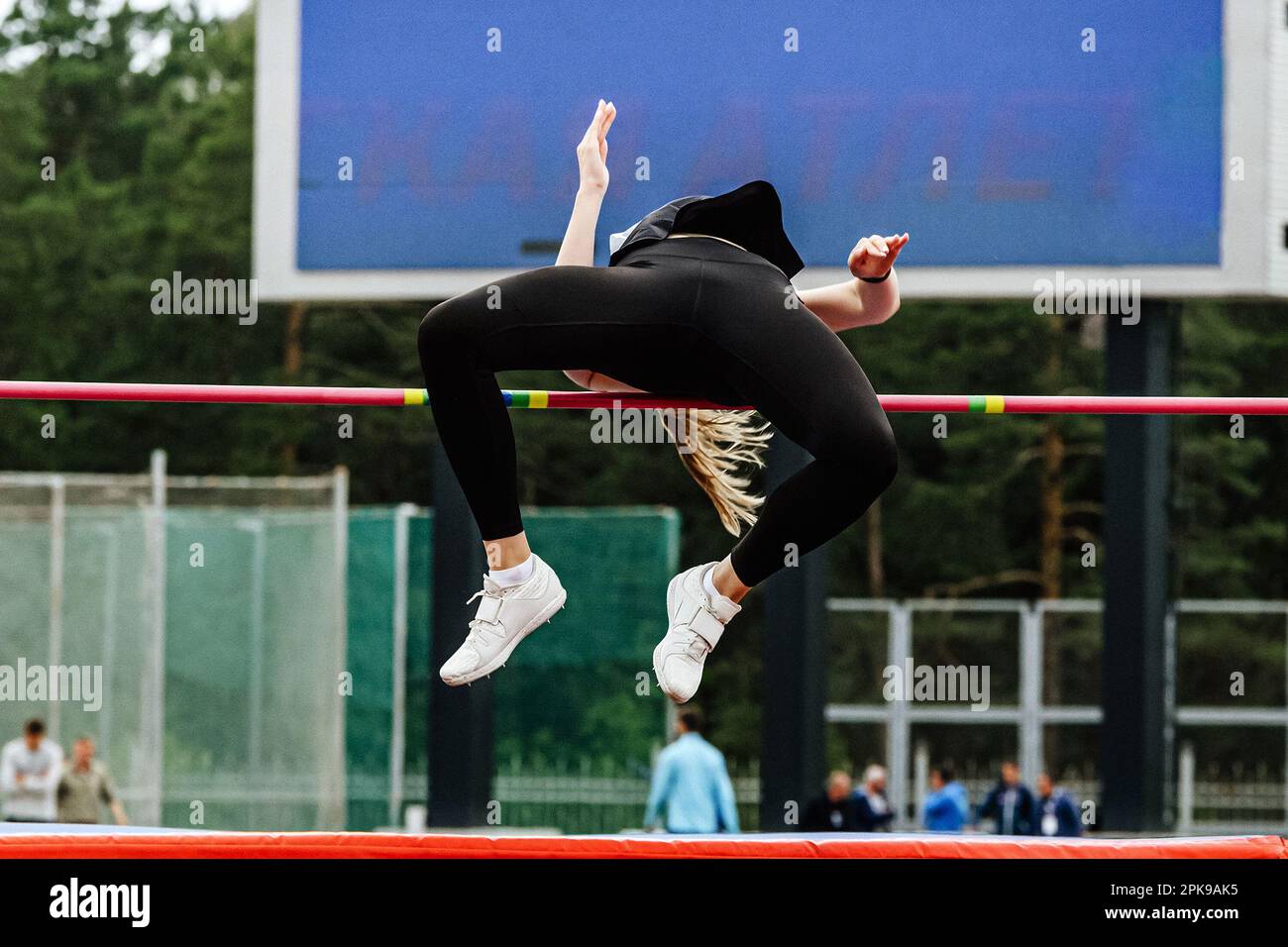 female jumper high jump side view in summer athletics championships