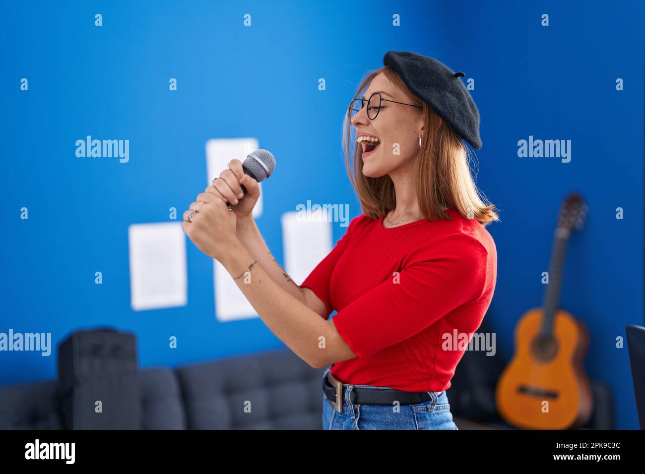 Red Tips Singer Young redhead woman artist singing song at music studio Stock Photo - Alamy