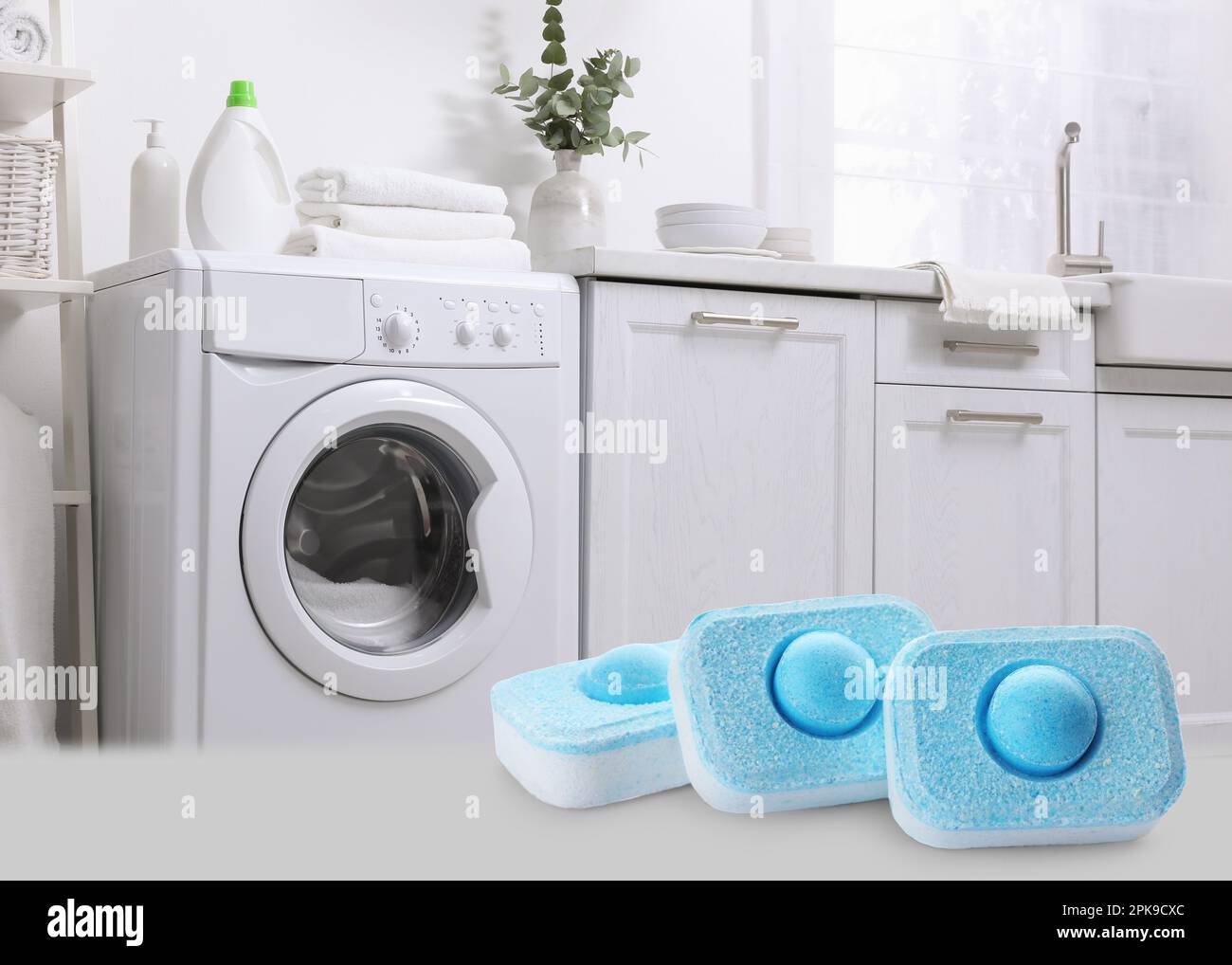 Image of water softener tablets and modern washing machine in laundry