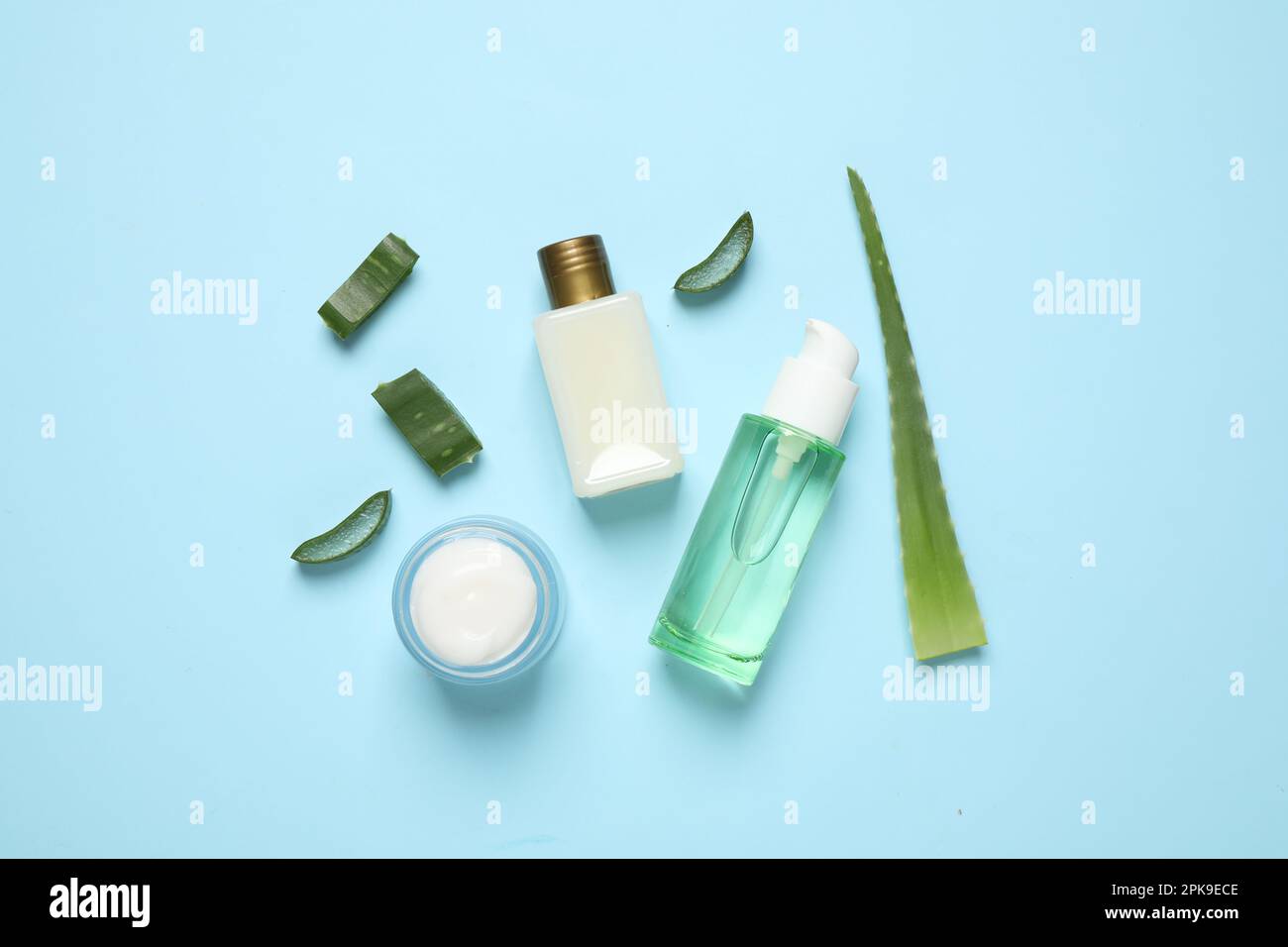 Flat lay composition with aloe vera and cosmetic products on light blue ...