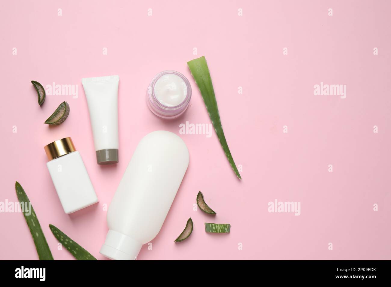 Flat lay composition with aloe vera and cosmetic products on pink ...
