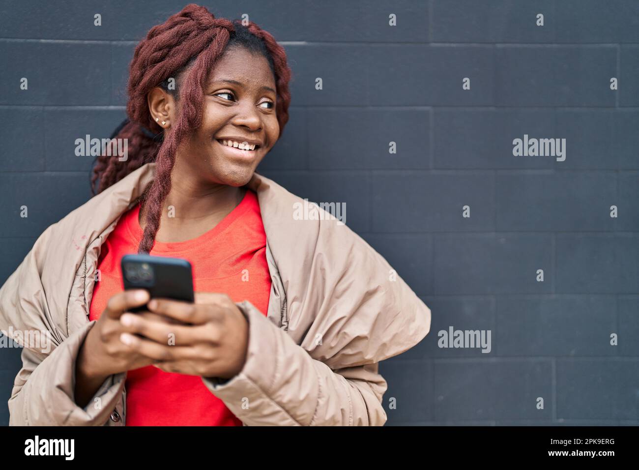 African american woman smiling confident using smartphone over isolated ...