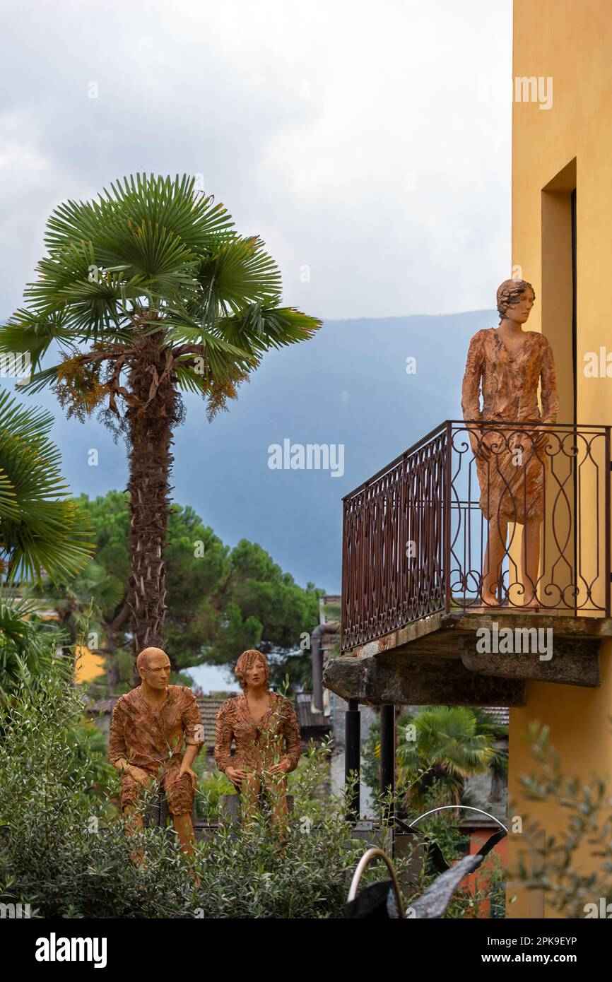 02.10.2016, Switzerland, Canton Ticino, Ascona - Life-size sculptures of people made of clay in a garden and balcony. 00A161002D285CAROEX.JPG [MODEL R Stock Photo