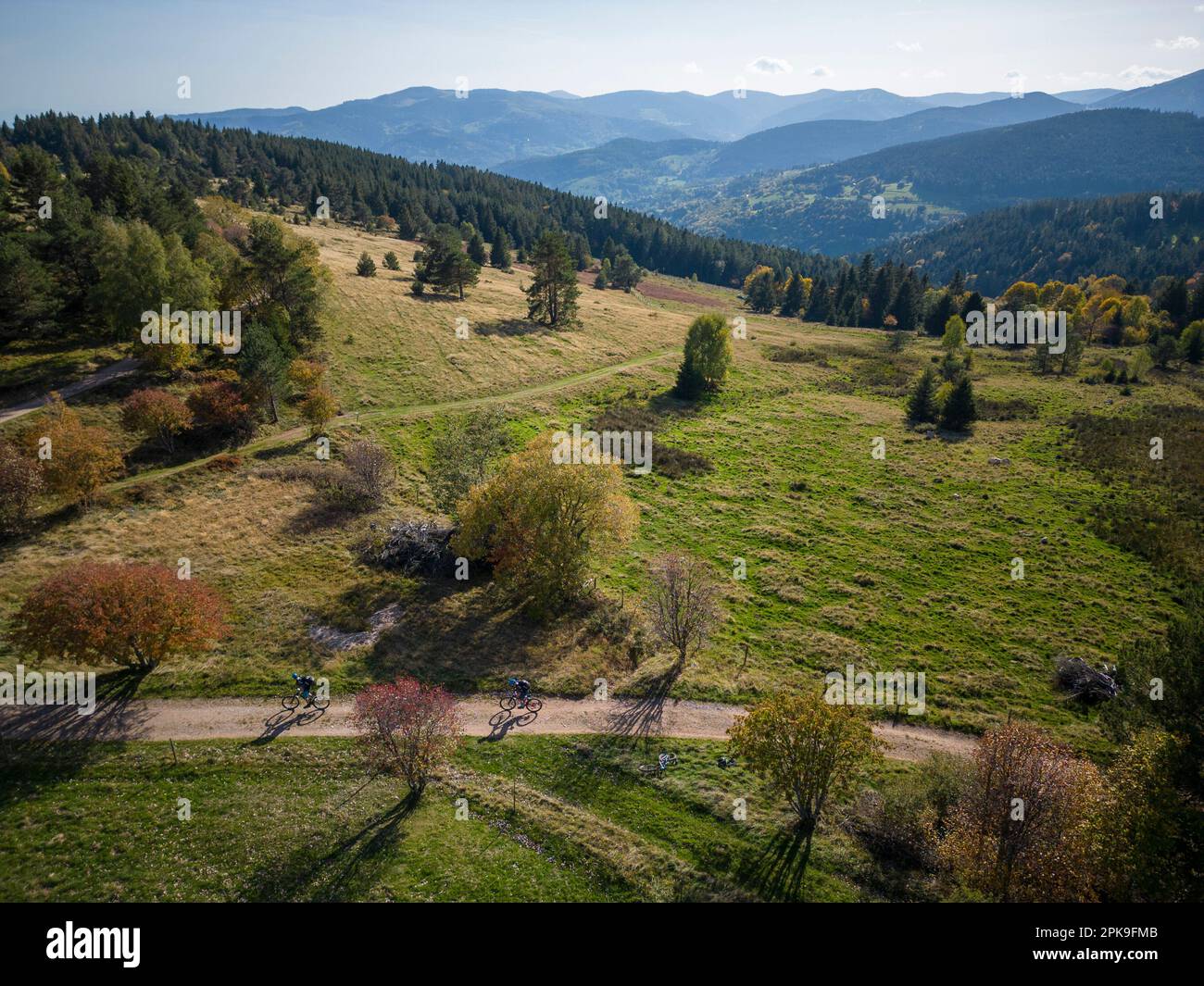 Mountain bikers near the Col du Wettstein. View of the surrounding Vosges mountains. Stock Photo