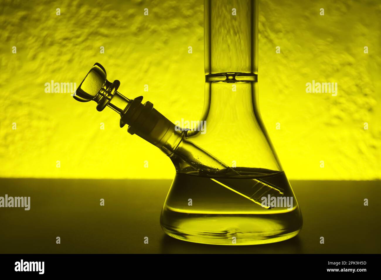 Closeup view of glass bong on table, toned in yellow. Smoking device Stock  Photo - Alamy