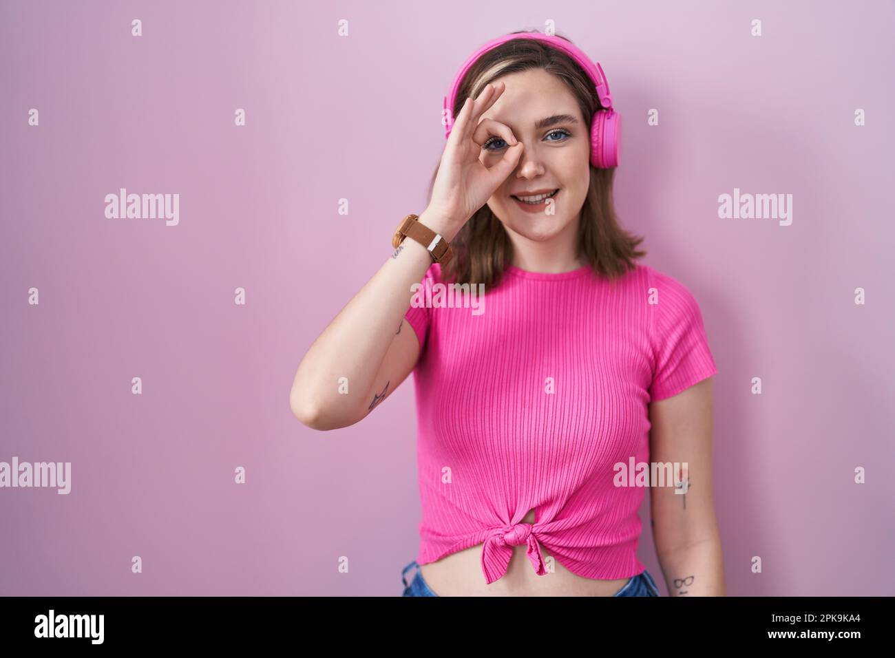 Blonde caucasian woman listening to music using headphones smiling ...