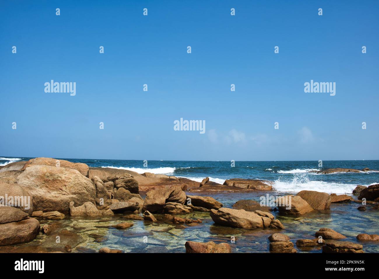 Rocky coast with eroded granite boulders, rock pools and waves at Cape Leeuwin, near Augusta in Western Australia Stock Photo