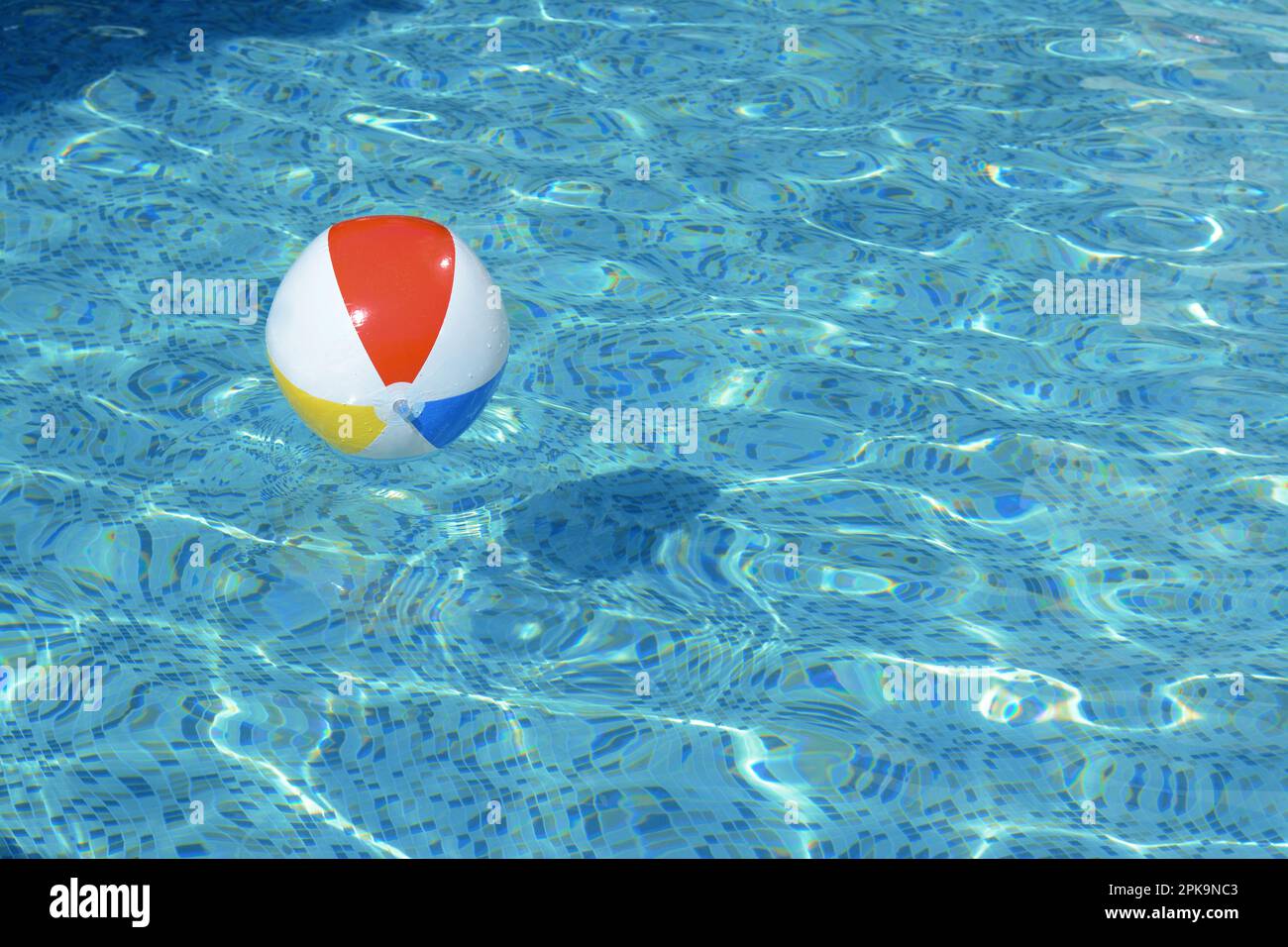 Inflatable beach ball floating in swimming pool, space for text Stock Photo Alamy