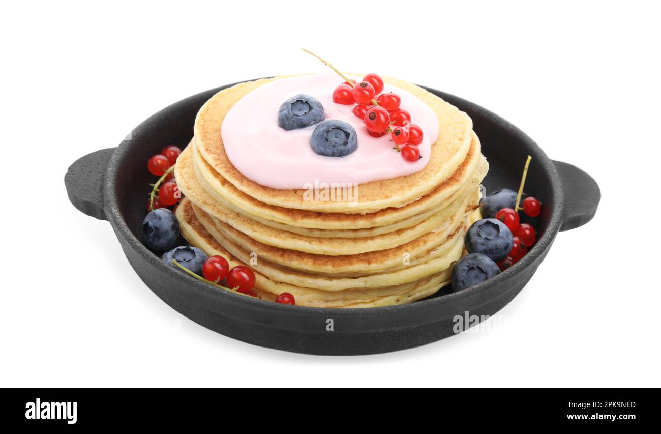 Tasty pancakes with natural yogurt, blueberries and red currants on white background Stock Photo