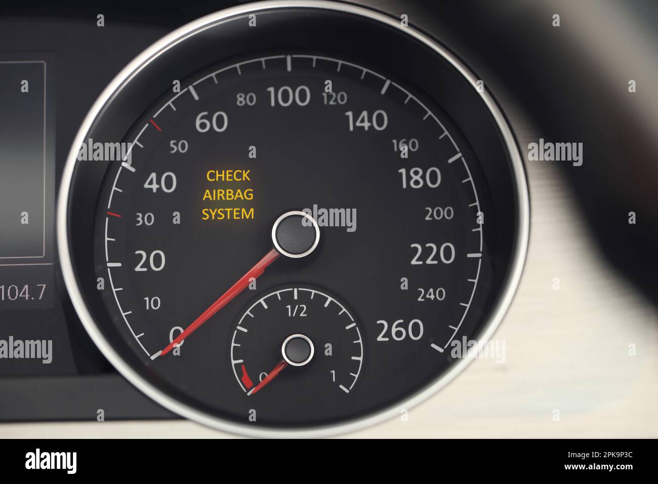 Closeup view of dashboard with warning icon check airbag system in car
