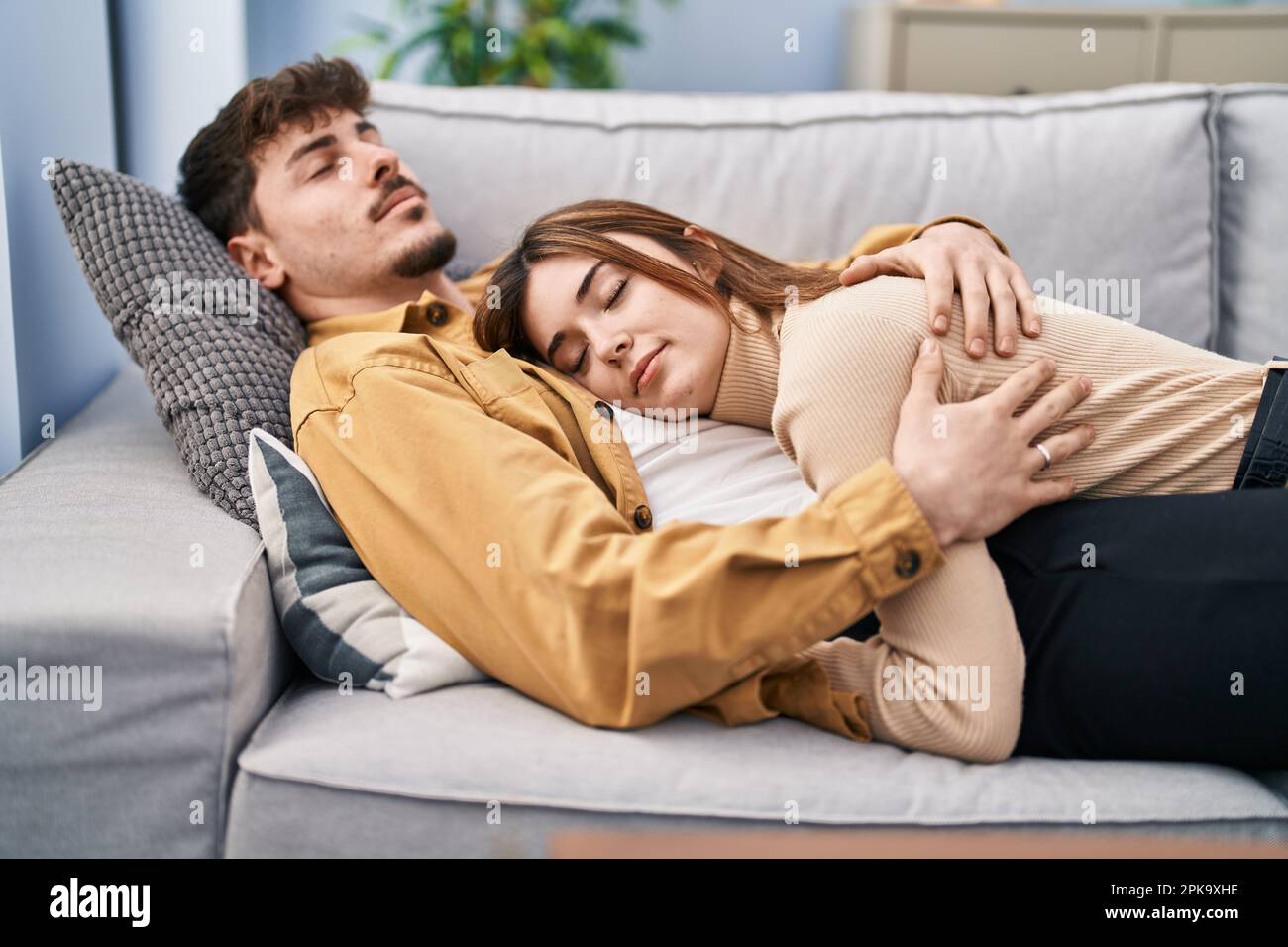 Mand and woman couple lying on sofa sleeping at home Stock Photo Alamy