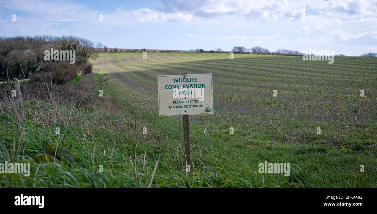 Wildlife conservation area sign by a field in the Sussex countryside Stock Photo