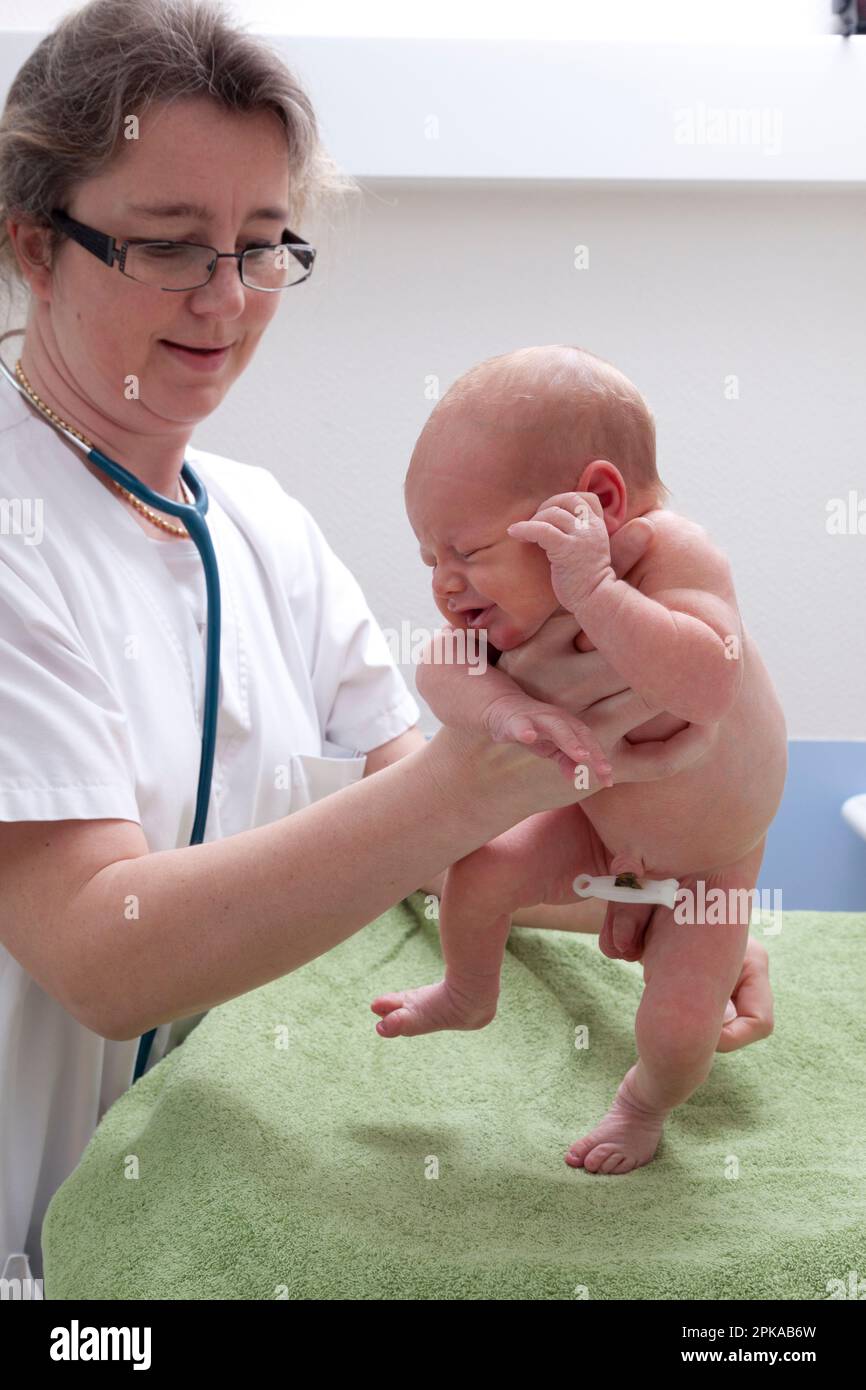 The automatic walking reflex is one of the archaic reflexes noted by the pediatrician during the neurological examination. Stock Photo