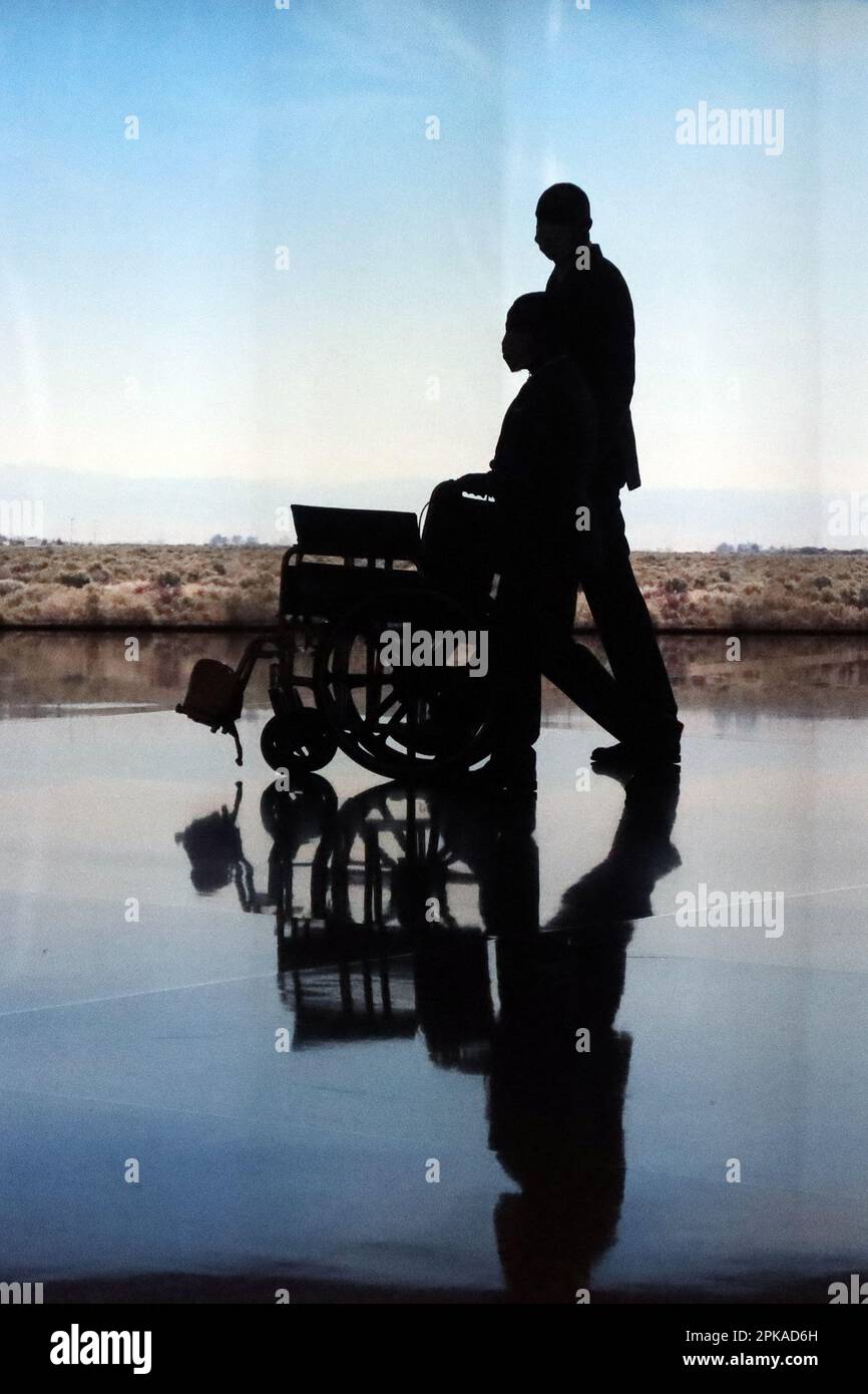 25.02.2023, Qatar, , Doha Silhouette Airport employee pushing an