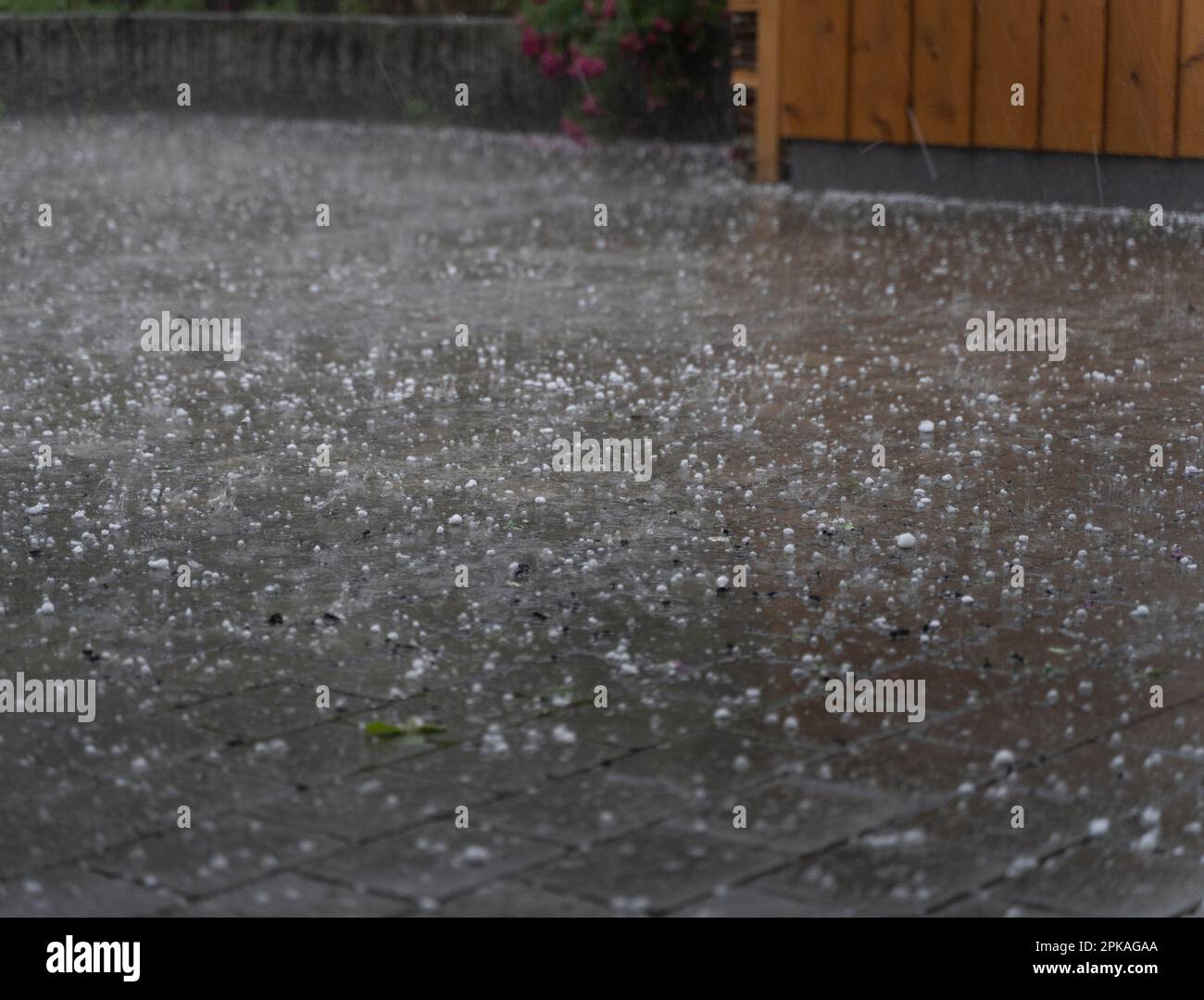 Hail and rain on a parking lot, thunderstorm in Garmisch-Partenkirchen, Bavaria, Germany Stock Photo