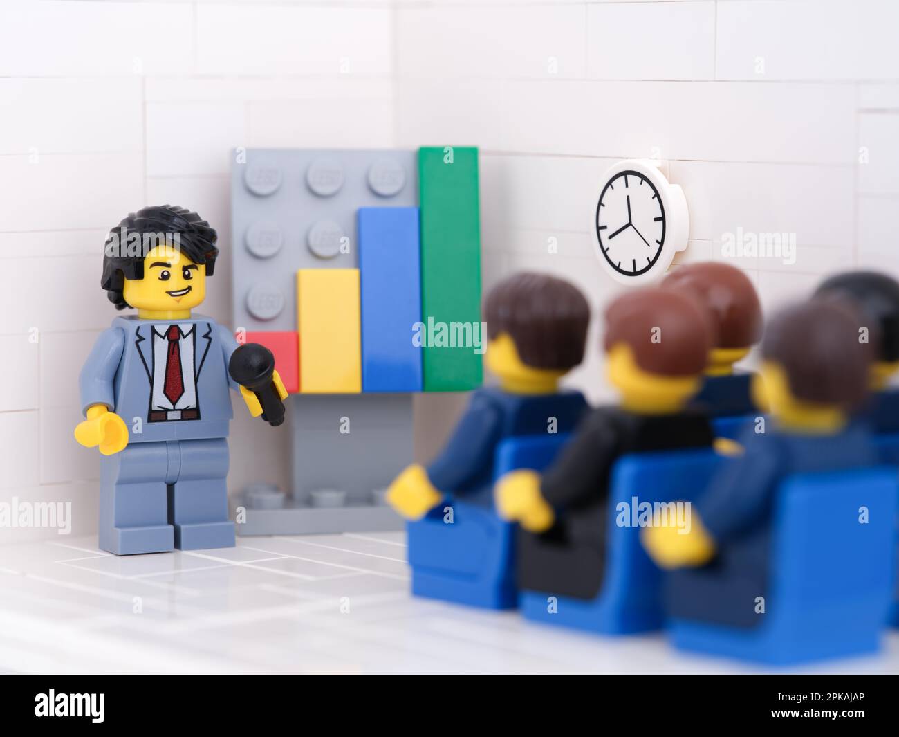 Tambov, Russian Federation - February 18, 2023 Lego businesspeople minifigures having a meeting and discussing graphs showing the results of their suc Stock Photo