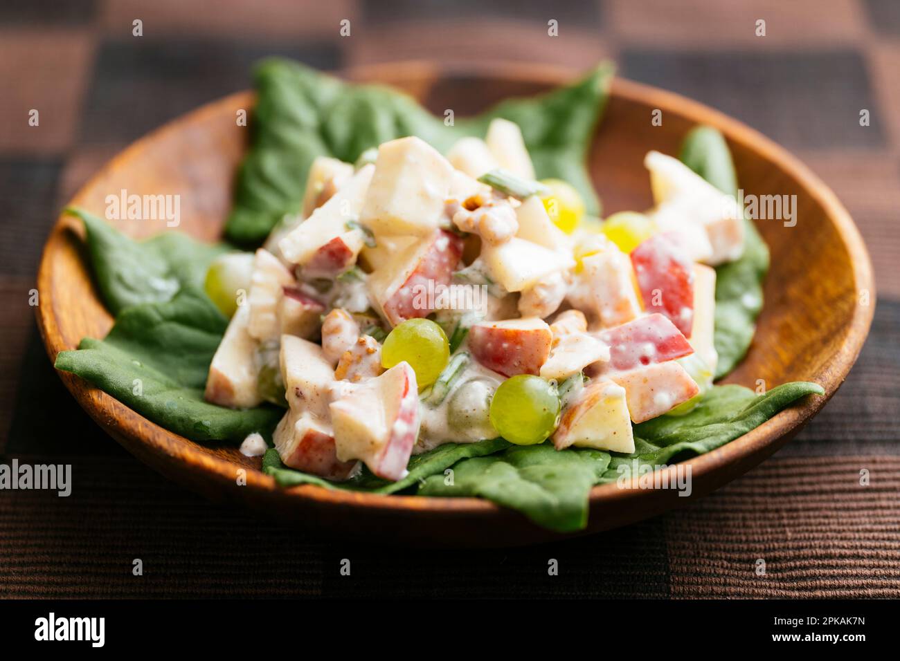 Traditional Waldorf salad with a vegan dressing on New Zealand spinach