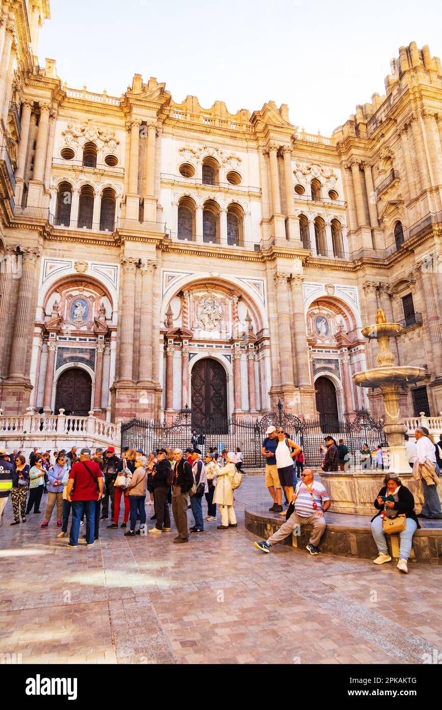 Tourists in Plaza del Obispo, outside The Roman Catholic Catedral de la Encaracion de Malaga. Malaga Cathedral. Calle Molina Lario. Malaga, Analusia, Stock Photo