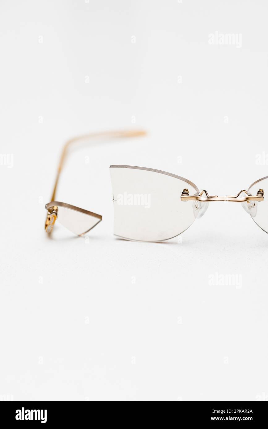 Broken lens of rimless glasses Stock Photo