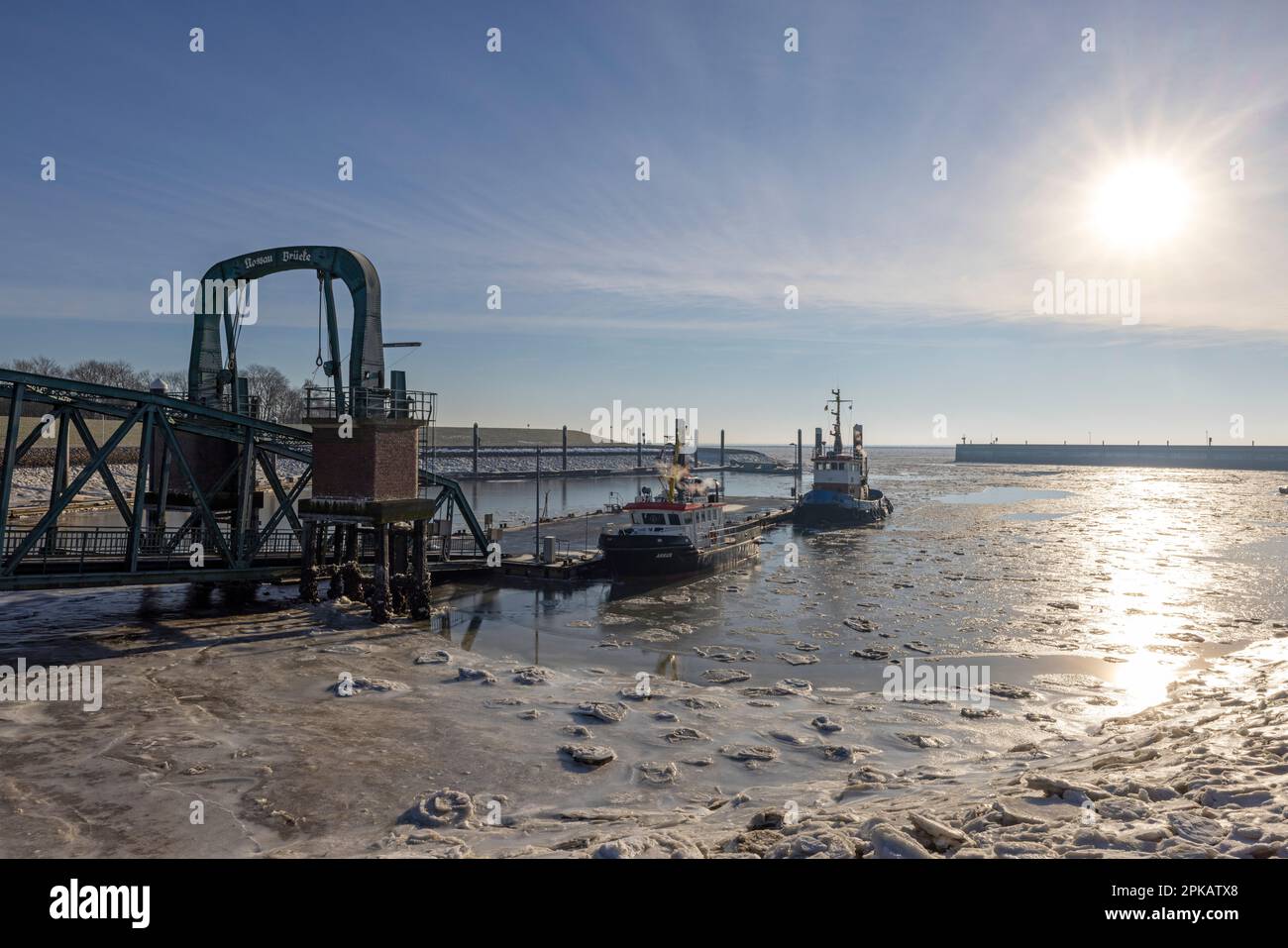Winter atmosphere, icy Nassau harbor, backlight shot, Wilhelmshaven, Lower Saxony, Germany Stock Photo