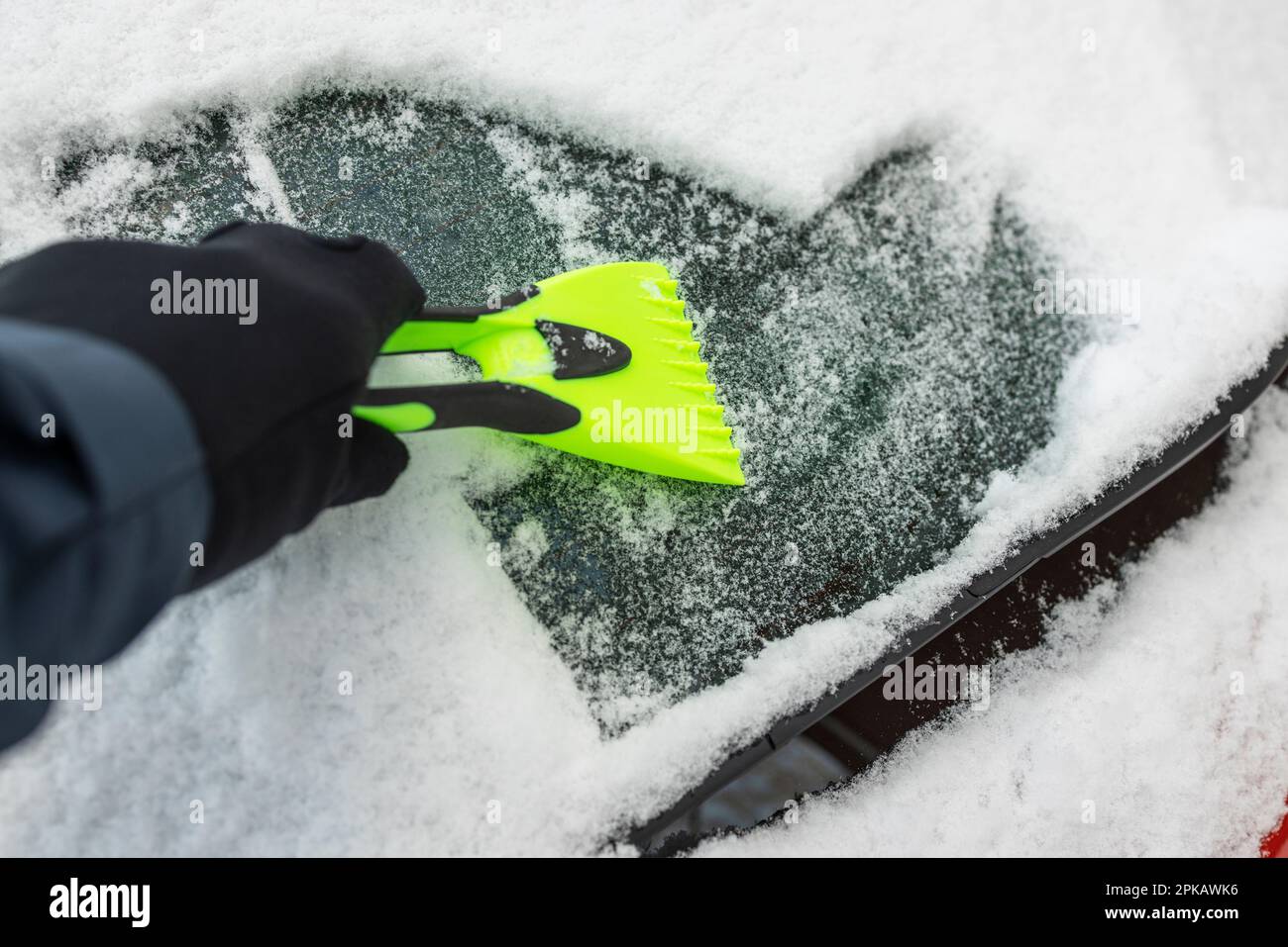 Motorist deicing windshield with ice scraper, detail Stock Photo Alamy