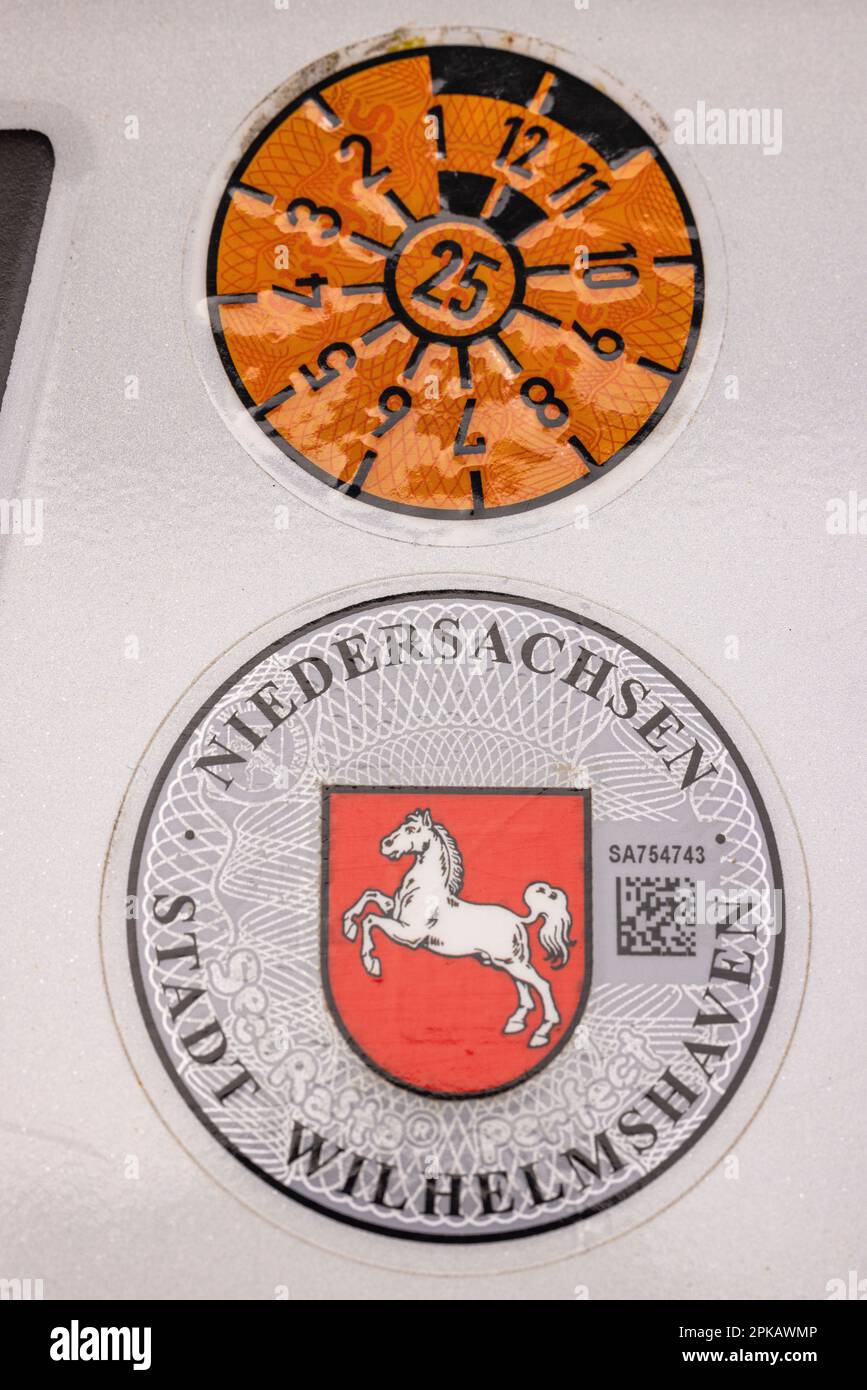 TÜV sticker, next general inspection January 2025, registration sticker of the city of Wilhelmshaven, on the rear license plate, Wilhelmshaven, Lower Saxony, Germany Stock Photo