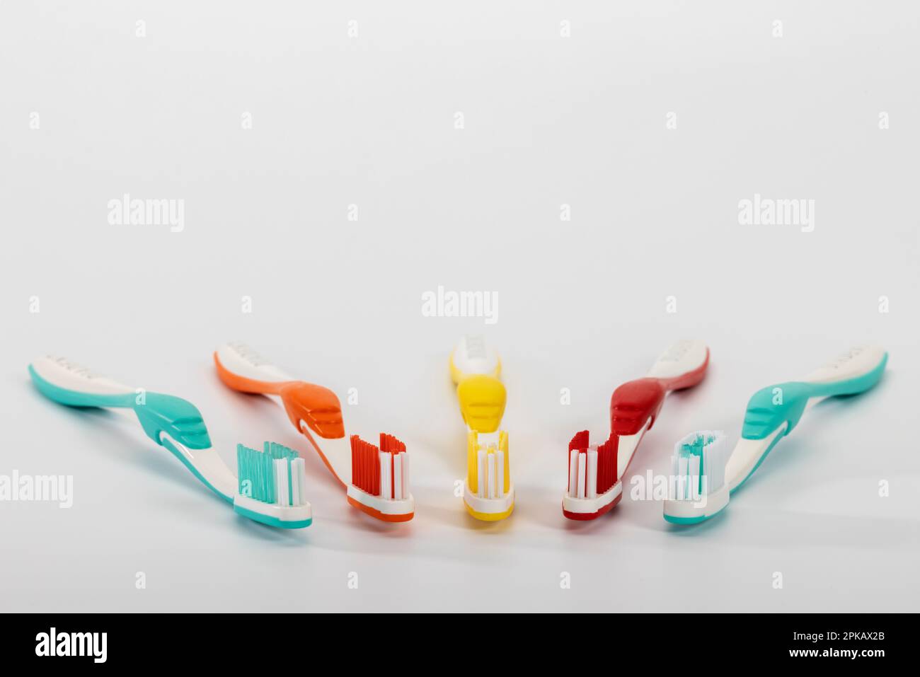 Five different colored manual toothbrushes, white background, symbol image, brushing teeth, dental care, white background, Stock Photo