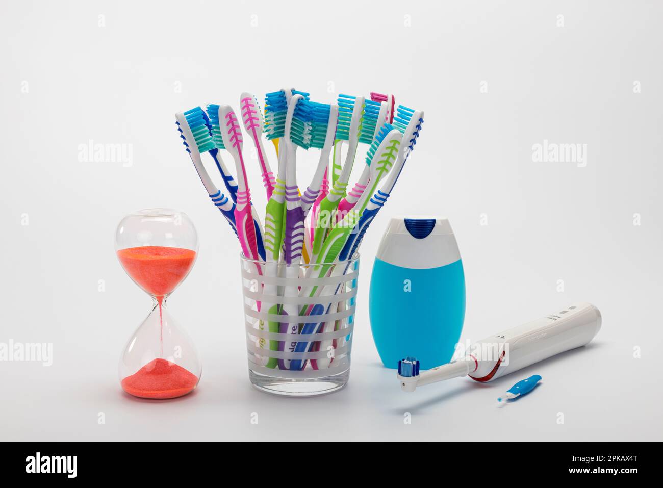 Hourglass, many toothbrushes in toothbrush cup, mouthwash, electric