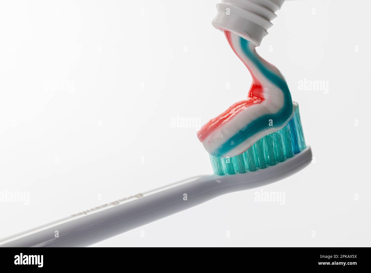 Toothpaste from toothpaste tube on toothbrush head, Philips Sonicare