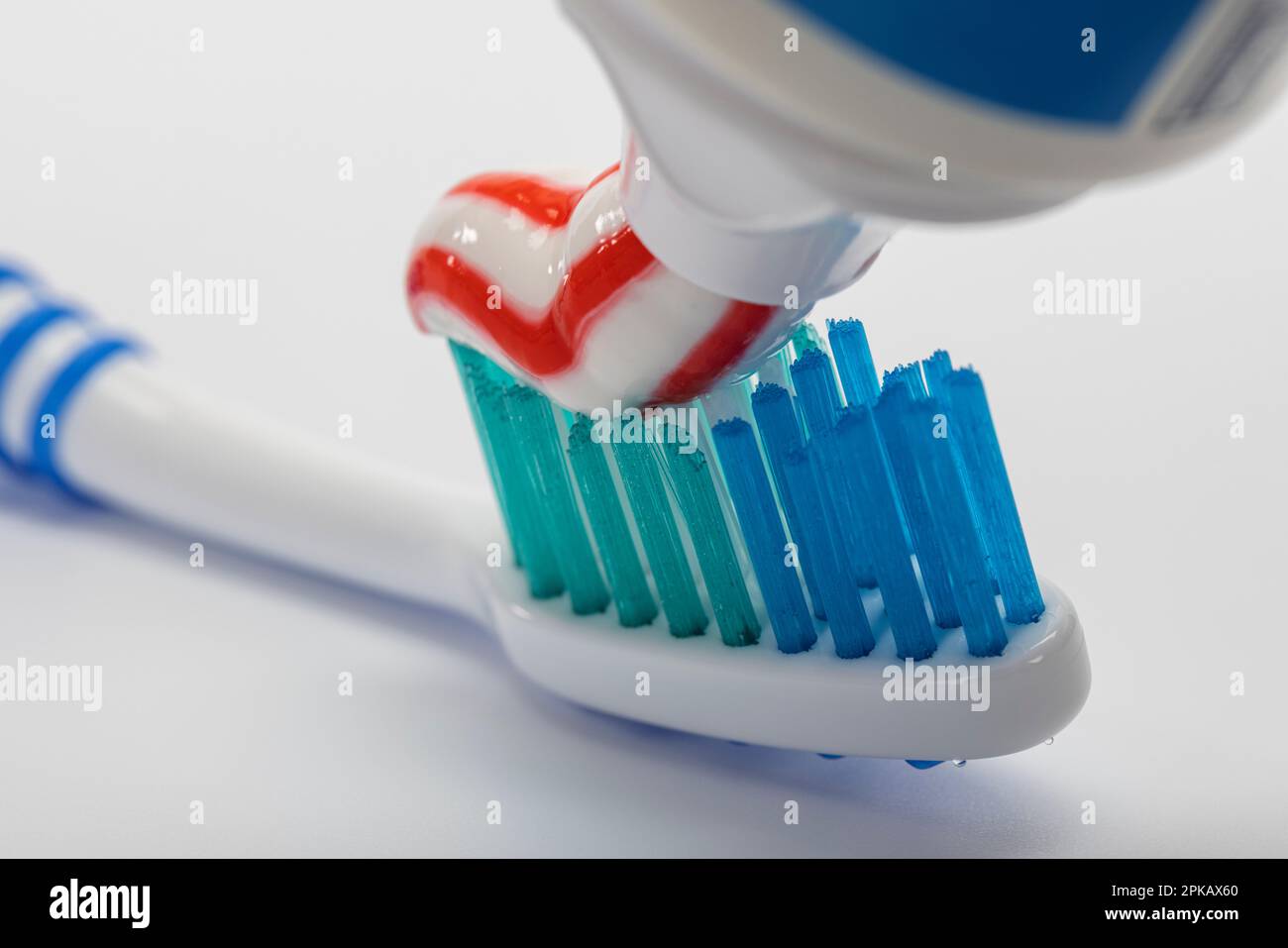 Applying toothpaste from toothpaste tube on toothbrush, detail, icon ...