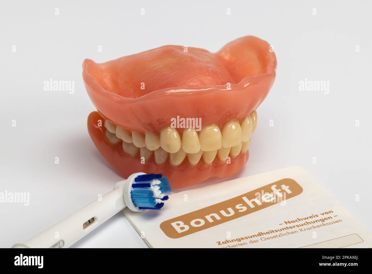 Denture, bonus booklet, attachment brush of an electric toothbrush, dental drill, symbol image