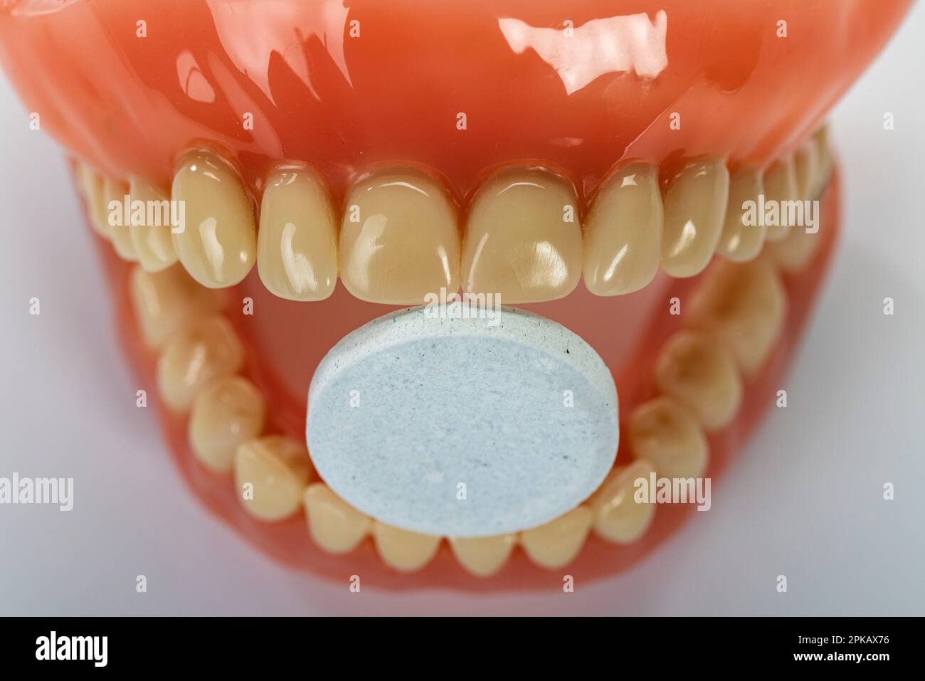 Denture with cleaning tablet, symbol image, clean dentures, white
