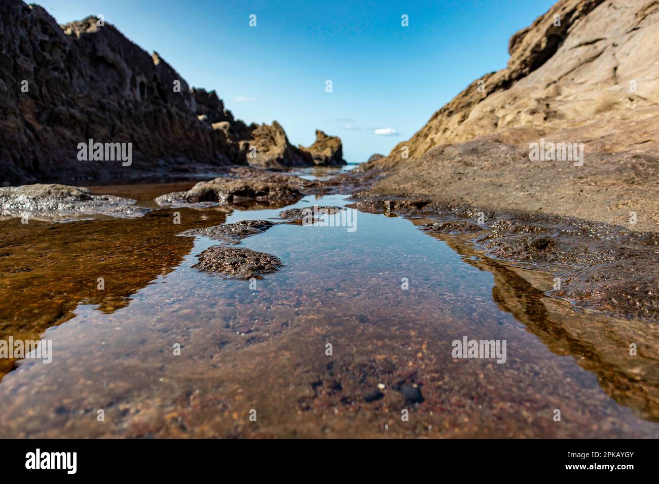 A tranquil, serene landscape featuring a small river winding through ...