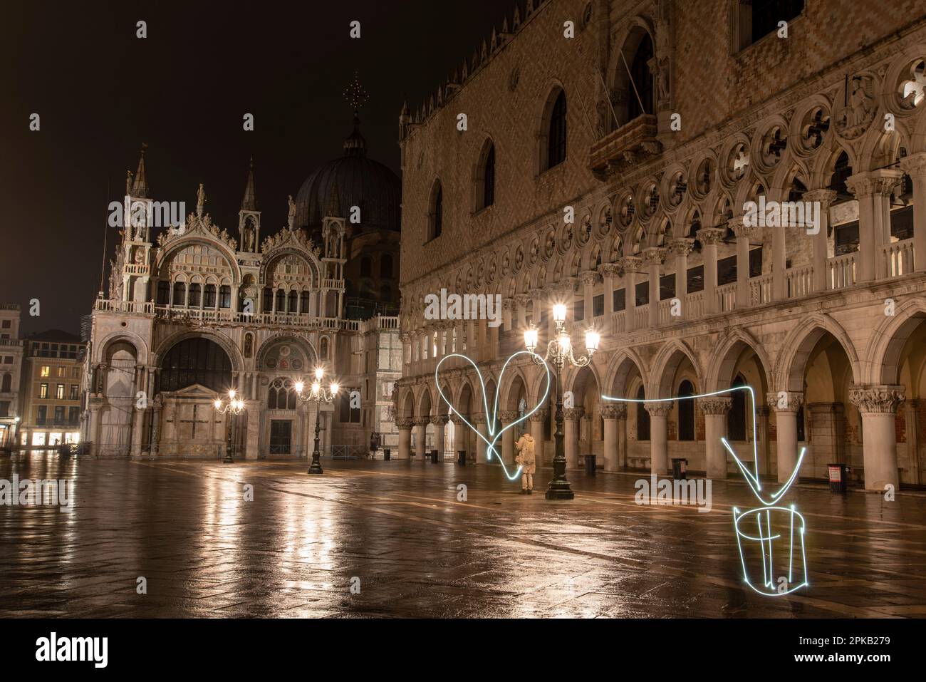 Writing with Light in front of the Illuminated Doge Palace on the Marks Square at Night, Venice, Italy Stock Photo