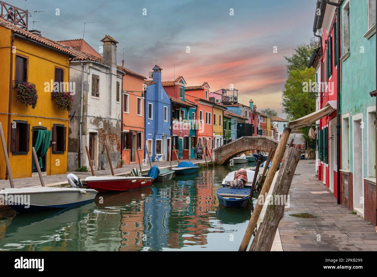 Colorful Houses in Burano beneath a scenic sky, Island of Venice, Italy Stock Photo