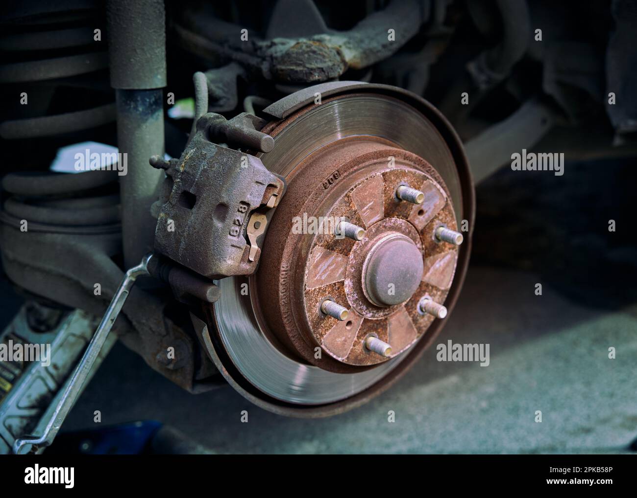 Car rusty brake rotor in automobile photo with tools Stock