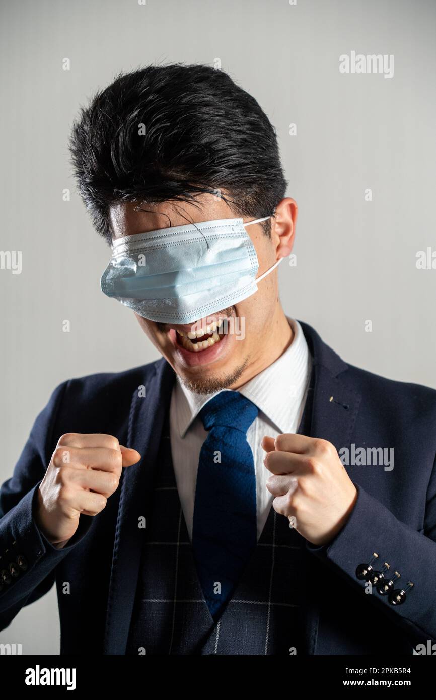 Screaming man wearing a mask over his eyes Stock Photo - Alamy